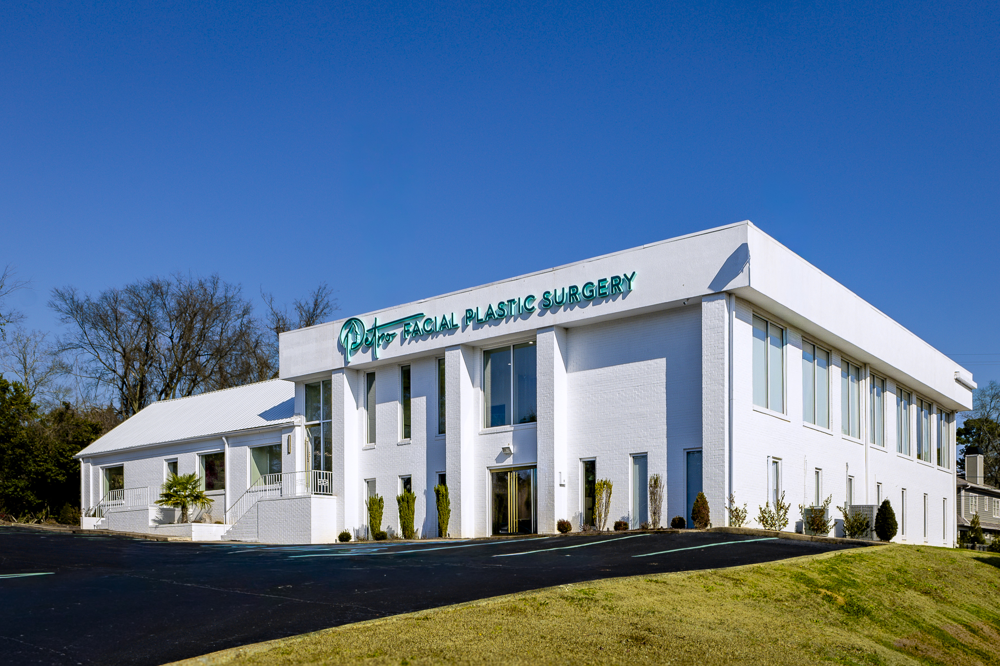 The Petro Facial Plastic Surgery building with its green sign and front entrances